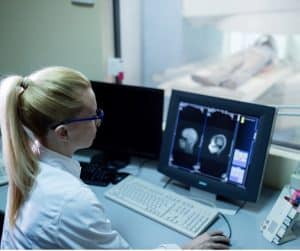 female radiologist examining mri scan results of a patient in control picture id1150879386 2